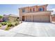 Two story home featuring a spacious two-car garage and well-maintained front yard landscaping at 1699 Sonoran Bluff Ave, Henderson, NV 89014