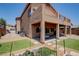 Two-story home showcasing a covered patio, second-floor balcony, well-maintained lawn, and a spacious backyard at 1699 Sonoran Bluff Ave, Henderson, NV 89014