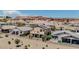Two-story home with a balcony and patio surrounded by lush landscaping and privacy walls at 1699 Sonoran Bluff Ave, Henderson, NV 89014