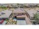 Two-story home featuring a 2-car garage, neutral stucco, desert landscaping, and a tile roof with solar panels at 1699 Sonoran Bluff Ave, Henderson, NV 89014