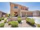 Two story home featuring a spacious two-car garage and well-maintained front yard desert landscaping at 1699 Sonoran Bluff Ave, Henderson, NV 89014