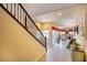 View of the foyer, tile floors, staircase and living room in an open floor plan at 1699 Sonoran Bluff Ave, Henderson, NV 89014
