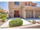 Inviting front entrance featuring desert landscaping, a neutral colored exterior, and a covered porch at 1699 Sonoran Bluff Ave, Henderson, NV 89014