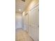 Hallway with neutral paint and flooring featuring a set of white doors at 1699 Sonoran Bluff Ave, Henderson, NV 89014