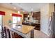 Open kitchen with island seating, stainless steel appliances, and dark cabinets at 1699 Sonoran Bluff Ave, Henderson, NV 89014