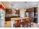 Modern kitchen with stainless steel appliances, granite countertops, and a breakfast bar at 1699 Sonoran Bluff Ave, Henderson, NV 89014