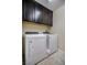 Laundry room with a washer, dryer, and upper cabinets for storage at 1699 Sonoran Bluff Ave, Henderson, NV 89014