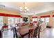Open-concept living room and dining area with tile floors, natural light, and modern decor at 1699 Sonoran Bluff Ave, Henderson, NV 89014