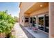 Cozy patio with comfortable seating, perfect for outdoor relaxation with a brick-paved walkway surrounded by lush landscaping at 1699 Sonoran Bluff Ave, Henderson, NV 89014