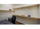 Spacious walk-in closet area providing ample storage and organization, featuring multiple shelves, closet rod, desk and chair at 1699 Sonoran Bluff Ave, Henderson, NV 89014