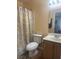 Bathroom features a tiled floor, toilet, vanity, mirror and a bathtub with a shower curtain at 2108 Willowbury Dr # B, Las Vegas, NV 89108