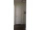 Hallway with a six panel door with gold hardware and dark wood-look vinyl floors at 2108 Willowbury Dr # B, Las Vegas, NV 89108