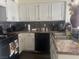 Kitchen with tile backsplash, granite countertops, stainless steel appliances, and white cabinetry at 2108 Willowbury Dr # B, Las Vegas, NV 89108