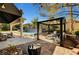 Inviting backyard with a covered patio, pool with waterfall feature, and cozy gazebo with comfortable seating at 2111 Bogart Ct, Las Vegas, NV 89117