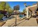 Backyard featuring pool with waterfall feature, patio, built-in grill, and mature landscaping for outdoor enjoyment at 2111 Bogart Ct, Las Vegas, NV 89117