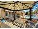 Backyard featuring covered patio, outdoor seating, a pristine pool with a waterfall, and a cozy gazebo at 2111 Bogart Ct, Las Vegas, NV 89117