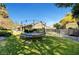 Backyard featuring a trampoline, manicured lawn, and lush landscaping, creating a private and serene outdoor space at 2111 Bogart Ct, Las Vegas, NV 89117