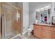 Bathroom with marble-look shower, vanity, mirror, and essential fixtures at 2111 Bogart Ct, Las Vegas, NV 89117
