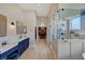 Long bathroom featuring dual vanities, a glass-enclosed shower, and wood-like flooring at 2111 Bogart Ct, Las Vegas, NV 89117