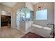 Stylish bathroom with a standalone tub, walk-in shower, and modern lighting fixture at 2111 Bogart Ct, Las Vegas, NV 89117