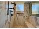 Shower featuring marble walls, a built-in bench, and modern fixtures at 2111 Bogart Ct, Las Vegas, NV 89117
