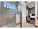 Modern bathroom showcasing a shower with glass door and the bedroom adjacent to it at 2111 Bogart Ct, Las Vegas, NV 89117