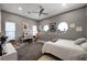 Inviting bedroom featuring arched windows, a ceiling fan, and a cozy bed at 2111 Bogart Ct, Las Vegas, NV 89117