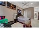 Well-lit bedroom with ceiling fan, neutral decor, and convenient access to the hallway at 2111 Bogart Ct, Las Vegas, NV 89117