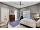 Cozy bedroom featuring neutral walls, ceiling fan, and a comfortable bed and stylish decor at 2111 Bogart Ct, Las Vegas, NV 89117