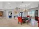 Formal dining room with a large chandelier, arched entry, and stylish decor at 2111 Bogart Ct, Las Vegas, NV 89117