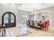 Elegant dining room with arched doorway, large window, and chandelier at 2111 Bogart Ct, Las Vegas, NV 89117