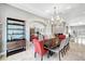 Dining room with a shelving unit, mirror, and stylish chandelier above table at 2111 Bogart Ct, Las Vegas, NV 89117