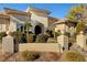 Inviting facade with an arched entryway, double doors, and meticulously kept landscaping that adds to the home's curb appeal at 2111 Bogart Ct, Las Vegas, NV 89117