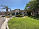 Lush front yard with manicured lawn, mature trees, and landscaping enhances the curb appeal of this beautiful home at 2111 Bogart Ct, Las Vegas, NV 89117