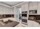 Gourmet kitchen with built-in stainless appliances and a cooktop island for seamless meal preparation at 2111 Bogart Ct, Las Vegas, NV 89117