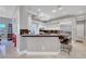 Modern kitchen with a breakfast bar, white cabinets, and stainless steel appliances at 2111 Bogart Ct, Las Vegas, NV 89117