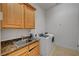 Convenient laundry room with washer, dryer, sink, and ample cabinet space for storage at 2111 Bogart Ct, Las Vegas, NV 89117