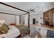 Large bedroom with a four-poster bed, tiled floors, and a stone fireplace at 2111 Bogart Ct, Las Vegas, NV 89117