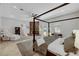 Spacious bedroom featuring a four-poster bed, fireplace, and ample natural light at 2111 Bogart Ct, Las Vegas, NV 89117