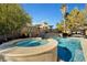 Beautiful pool and spa area with stone accents, tropical landscaping, and cozy gazebo for outdoor enjoyment at 2111 Bogart Ct, Las Vegas, NV 89117