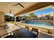 Scenic backyard featuring pool, patio, and lush greenery at 2111 Bogart Ct, Las Vegas, NV 89117