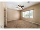 Comfortable bedroom featuring neutral walls, plush carpeting, and a ceiling fan at 2708 Cheer Pheasant Ave, North Las Vegas, NV 89084