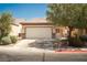 Charming single-story home featuring a two-car garage, desert landscaping, and a welcoming entrance at 2708 Cheer Pheasant Ave, North Las Vegas, NV 89084