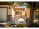 Inviting front porch featuring a decorative security gate, manicured desert landscaping, and stone accents at 2708 Cheer Pheasant Ave, North Las Vegas, NV 89084