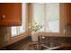 Close-up of kitchen sink and window showcasing granite countertops and bright, natural light at 2708 Cheer Pheasant Ave, North Las Vegas, NV 89084