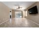 Expansive living room showcasing tile flooring, neutral walls, a ceiling fan, and backyard views at 2708 Cheer Pheasant Ave, North Las Vegas, NV 89084