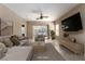 Spacious living room featuring tile floors, a ceiling fan, and sliding glass doors to the backyard at 2708 Cheer Pheasant Ave, North Las Vegas, NV 89084