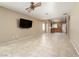 Open concept living room with tile floors, natural lighting, and views of the kitchen area at 2708 Cheer Pheasant Ave, North Las Vegas, NV 89084