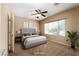 Cozy bedroom featuring a ceiling fan, a large window, and neutral décor creating a relaxing atmosphere at 2708 Cheer Pheasant Ave, North Las Vegas, NV 89084