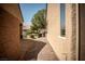 Paver walkway between two homes, leading to a landscaped yard with a mature tree in a residential setting at 2708 Cheer Pheasant Ave, North Las Vegas, NV 89084
